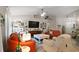 A bright living room showcases a TV, seating, decor and access to other areas of the home at 318 Stone Castle Loop, Lady Lake, FL 32159