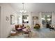 Cozy seating area with large windows, stylish decor and access to an outdoor patio at 318 Stone Castle Loop, Lady Lake, FL 32159
