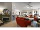 Open-concept living area showcases a fireplace, bar seating, natural light, and modern design at 318 Stone Castle Loop, Lady Lake, FL 32159
