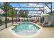 Screened-in pool with slide, lounge chairs, and table with chairs offers a relaxing outdoor space at 318 Stone Castle Loop, Lady Lake, FL 32159