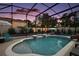 Enjoy a refreshing swim in this screened pool, complete with a slide and lounging area at 318 Stone Castle Loop, Lady Lake, FL 32159