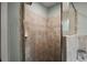 Tiled shower features glass doors and built-in shelves at 318 Stone Castle Loop, Lady Lake, FL 32159