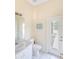 Bright bathroom with a single sink vanity, a toilet, and an exterior glass paneled door at 32025 Timberlake Dr, Mount Dora, FL 32757