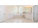 Bright bathroom boasts tiled floor, jetted tub, and double vanity, providing a comfortable spa-like retreat at 32025 Timberlake Dr, Mount Dora, FL 32757
