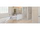 Well-appointed bathroom features a jetted tub, vanity with ample storage, and a separate toilet area at 32025 Timberlake Dr, Mount Dora, FL 32757
