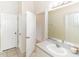 Bathroom with a single sink vanity, light gray countertop, and doors opening to other rooms at 32025 Timberlake Dr, Mount Dora, FL 32757