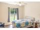 Cozy bedroom with natural light from a large window creates a peaceful retreat at 32025 Timberlake Dr, Mount Dora, FL 32757