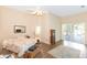Open bedroom with wood floors and access to the screened porch provides a relaxing and airy space at 32025 Timberlake Dr, Mount Dora, FL 32757
