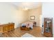 Bright bedroom features wood floors, ceiling fan, and simple decor for a cozy, inviting atmosphere at 32025 Timberlake Dr, Mount Dora, FL 32757