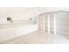 Bonus room with custom shelving and storage; bright, tiled floors, and a ceiling fan at 32025 Timberlake Dr, Mount Dora, FL 32757