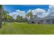 Long driveway leading to the home and garage, surrounded by green lawns and mature trees at 32025 Timberlake Dr, Mount Dora, FL 32757