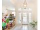 Bright foyer featuring tile floors, a statement light fixture, and double glass doors at 32025 Timberlake Dr, Mount Dora, FL 32757