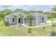 Beautiful single-story home with a lush green lawn and mature palm trees, offering great curb appeal at 32025 Timberlake Dr, Mount Dora, FL 32757