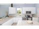 Well-equipped kitchen with white cabinets, stainless steel appliances, and a view to the backyard at 32025 Timberlake Dr, Mount Dora, FL 32757
