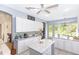 Bright kitchen with white cabinets, tile backsplash, and a center island at 32025 Timberlake Dr, Mount Dora, FL 32757