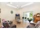 Spacious living room featuring wood floors, a ceiling fan, and a sliding glass door to the outdoors at 32025 Timberlake Dr, Mount Dora, FL 32757