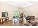 Spacious living room featuring wood floors, a ceiling fan, and a sliding glass door to the outdoors at 32025 Timberlake Dr, Mount Dora, FL 32757