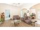 Open-concept living room with wood floors, ample seating, and a view of other rooms at 32025 Timberlake Dr, Mount Dora, FL 32757