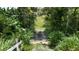 Path leading through lush plants and trees adds a sense of adventure to the property at 32025 Timberlake Dr, Mount Dora, FL 32757