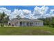 Spacious backyard showcasing the expansive lawn and screened patio for outdoor enjoyment at 32025 Timberlake Dr, Mount Dora, FL 32757