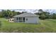 Back of the home featuring a screened-in porch, perfect for enjoying the outdoors in comfort at 32025 Timberlake Dr, Mount Dora, FL 32757