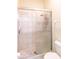 Shower with glass doors and tiled walls and flooring; showerhead is mounted high on the wall at 32025 Timberlake Dr, Mount Dora, FL 32757