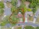 Aerial shot of the property in a charming neighborhood with mature trees and well-maintained landscaping at 3904 Valencia Grove Ln, Orlando, FL 32817