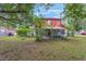 Beautiful backyard featuring a screened in porch, a lawn, and mature trees at 3904 Valencia Grove Ln, Orlando, FL 32817