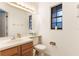 Half bath featuring a single sink, toilet, and wood cabinets, with a window for natural light at 3904 Valencia Grove Ln, Orlando, FL 32817