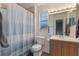 Bathroom featuring a single sink, wood cabinets, a white shower curtain, and wood flooring at 3904 Valencia Grove Ln, Orlando, FL 32817