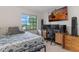 Comfortable bedroom featuring a sunset view on television, a desk, and natural light at 3904 Valencia Grove Ln, Orlando, FL 32817