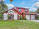 Charming two-story home featuring a well-maintained lawn, two-car garage, and colorful exterior paint at 3904 Valencia Grove Ln, Orlando, FL 32817