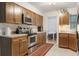Charming kitchen featuring stainless steel appliances and light wood cabinetry at 3904 Valencia Grove Ln, Orlando, FL 32817