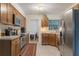 Well-lit kitchen featuring stainless steel appliances and light wood cabinetry at 3904 Valencia Grove Ln, Orlando, FL 32817