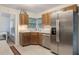 Cozy kitchen featuring stainless steel appliances and light wood cabinetry at 3904 Valencia Grove Ln, Orlando, FL 32817