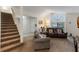 Spacious living room showcasing a staircase, neutral carpet, and comfortable seating arrangement at 3904 Valencia Grove Ln, Orlando, FL 32817