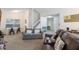 Open-concept living room features stairs, neutral carpet, dining area, and comfortable seating at 3904 Valencia Grove Ln, Orlando, FL 32817