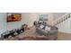 Bright living room featuring neutral carpet, a large window, a TV, and comfortable seating arrangement at 3904 Valencia Grove Ln, Orlando, FL 32817