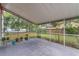Relaxing screened-in patio with concrete flooring and views of the landscaped backyard at 3904 Valencia Grove Ln, Orlando, FL 32817
