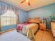 A bedroom featuring carpet, a ceiling fan, a bed, a window, and other decor at 428 Coventry Estates Blvd, Deltona, FL 32725