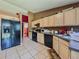 Functional kitchen with sleek black appliances, ample counter space, and neutral-toned cabinetry at 428 Coventry Estates Blvd, Deltona, FL 32725