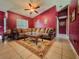 The living room has beautiful tile flooring, ceiling fan, large L shape sofa at 428 Coventry Estates Blvd, Deltona, FL 32725