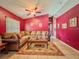 The living room features tile flooring, a ceiling fan, and a comfortable L-shaped sofa at 428 Coventry Estates Blvd, Deltona, FL 32725
