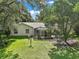 The backyard features lush green grass and a screened-in lanai, perfect for outdoor entertaining at 4300 Leafway Cir, Leesburg, FL 34748