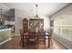 Dining area with wood floors, a china cabinet, and a large window offering natural light at 4300 Leafway Cir, Leesburg, FL 34748