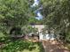 Charming home with a well-maintained front yard, mature trees, and an attached two-car garage at 4300 Leafway Cir, Leesburg, FL 34748
