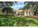 Charming single-story home with lush landscaping, a screened entrance, and a two-car garage at 4300 Leafway Cir, Leesburg, FL 34748