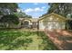 Charming single-story home with lush landscaping, a screened entrance, and a two-car garage at 4300 Leafway Cir, Leesburg, FL 34748