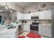 Modern kitchen with stainless steel appliances, white cabinetry, and a bright, airy atmosphere at 4300 Leafway Cir, Leesburg, FL 34748