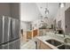 Bright kitchen featuring a breakfast bar, tiled floor, and modern stainless steel refrigerator at 4300 Leafway Cir, Leesburg, FL 34748